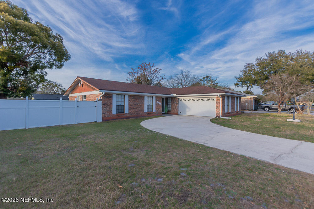 8209 Worm Wood Road Jacksonville, FL 32210 - Photo 1 of 44 front view of a house with a big yard