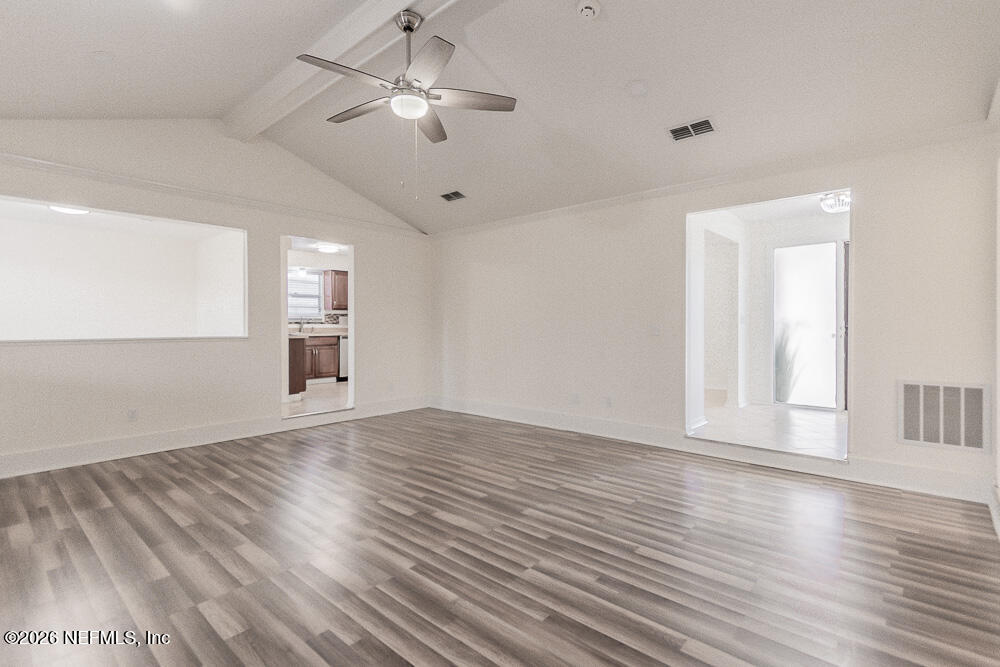 8209 Worm Wood Road Jacksonville, FL 32210 - Photo 17 of 44 a view of empty room with wooden floor and fan