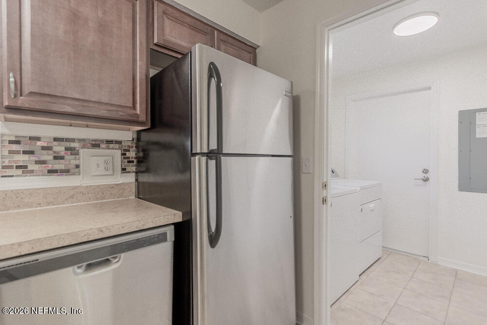 8209 Worm Wood Road Jacksonville, FL 32210 - Photo 20 of 44 a white refrigerator freezer and a stove sitting inside of a kitchen