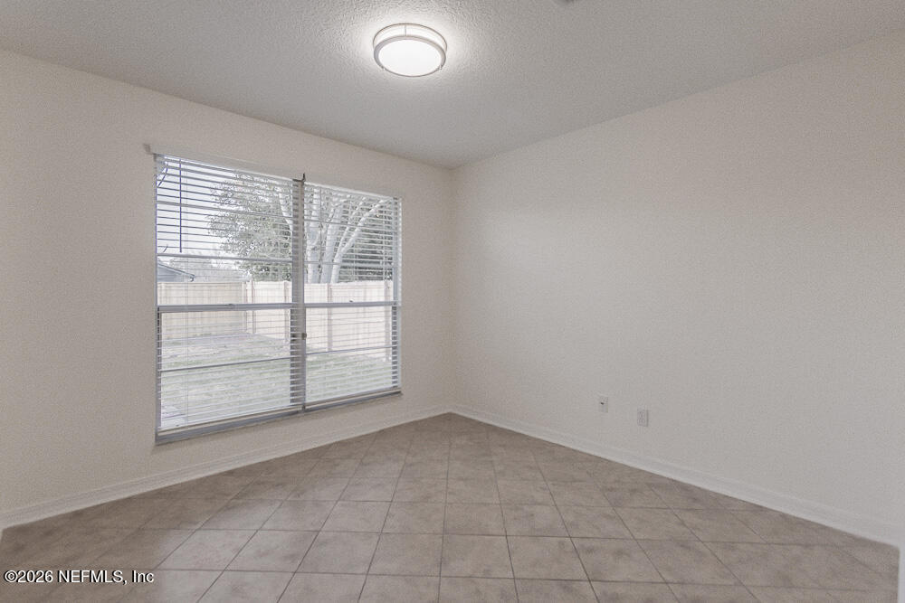 8209 Worm Wood Road Jacksonville, FL 32210 - Photo 21 of 44 an empty room with windows