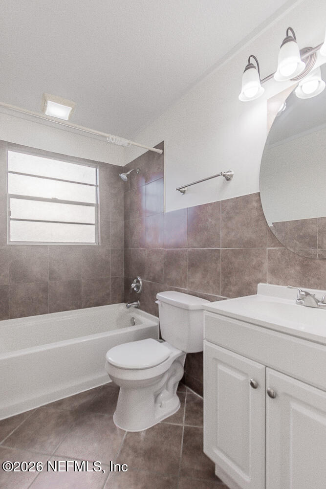 8209 Worm Wood Road Jacksonville, FL 32210 - Photo 33 of 44 a bathroom with a sink a toilet and bathtub