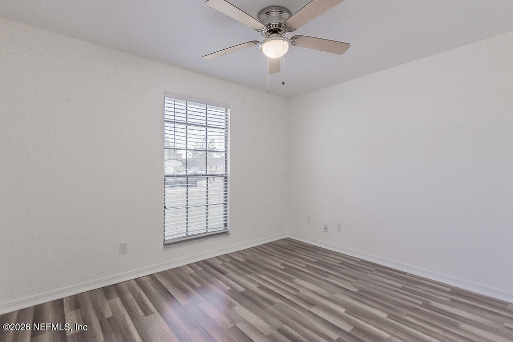 8209 Worm Wood Road Jacksonville, FL 32210 - Photo 35 of 44 wooden floor in an empty room with a window
