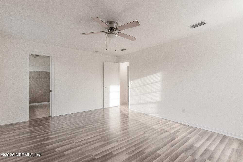 8209 Worm Wood Road Jacksonville, FL 32210 - Photo 4 of 44 a view of an empty room and wooden floor