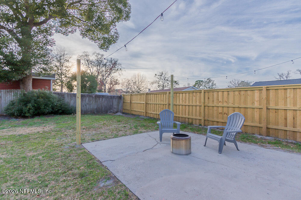 8209 Worm Wood Road Jacksonville, FL 32210 - Photo 42 of 44 a view of a chair and table in backyard