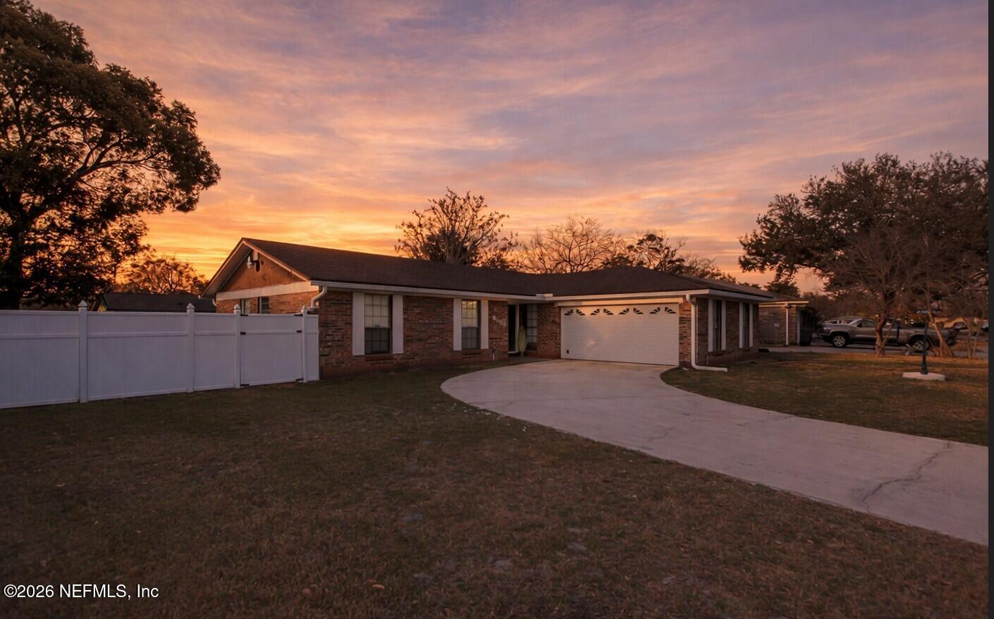 8209 Worm Wood Road Jacksonville, FL 32210 - Photo 43 of 44 a front view of a house with a yard and garage