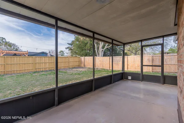 a view of an empty room with a floor to ceiling window