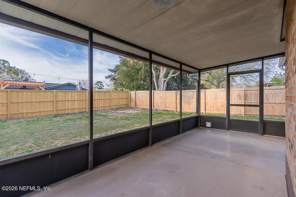 8209 Worm Wood Road Jacksonville, FL 32210 - Photo 6 of 44 a view of an empty room with a floor to ceiling window
