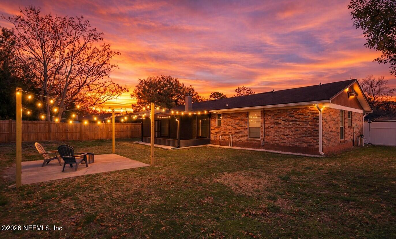 8209 Worm Wood Road Jacksonville, FL 32210 - Photo 8 of 44 a backyard of a house with table and chairs