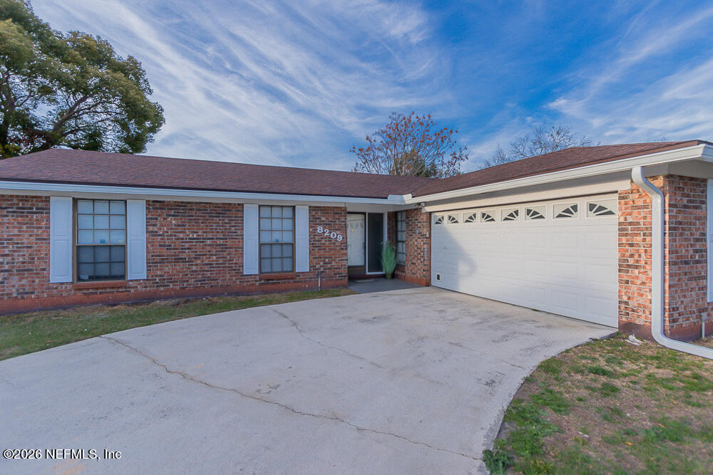 8209 Worm Wood Road Jacksonville, FL 32210 - Photo 10 of 44 front view of a house with a garage
