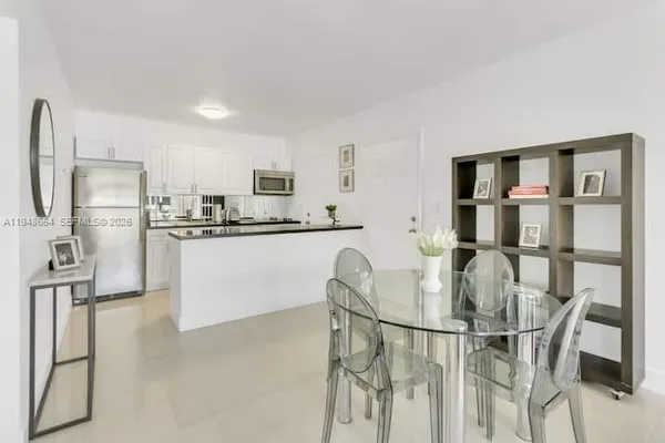 a kitchen with stainless steel appliances a refrigerator and microwave