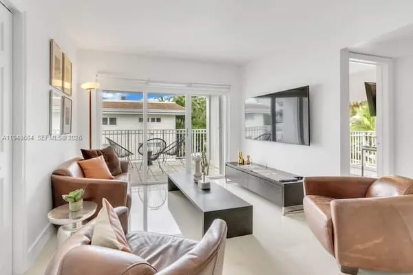 a living room with furniture a window and a table