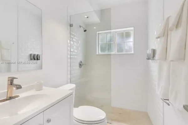 a bathroom with a sink toilet tub and shower
