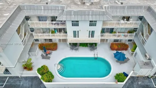 an aerial view of residential houses with outdoor space and swimming pool