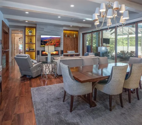 a dining room with furniture a rug and wooden floor