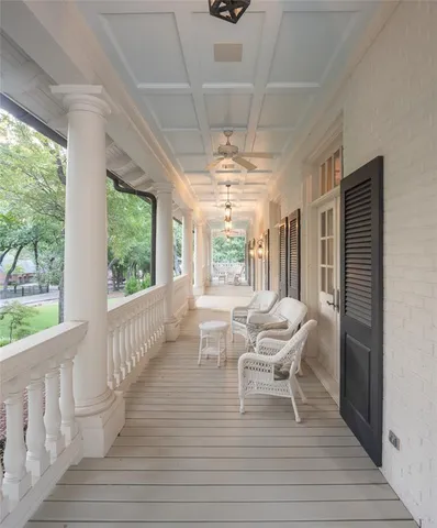 a dining room with furniture a chandelier and wooden floor