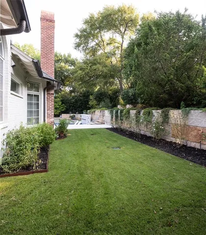 a view of a big yard with a trees