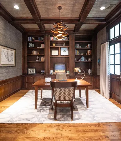 a dining room with furniture a rug and a chandelier