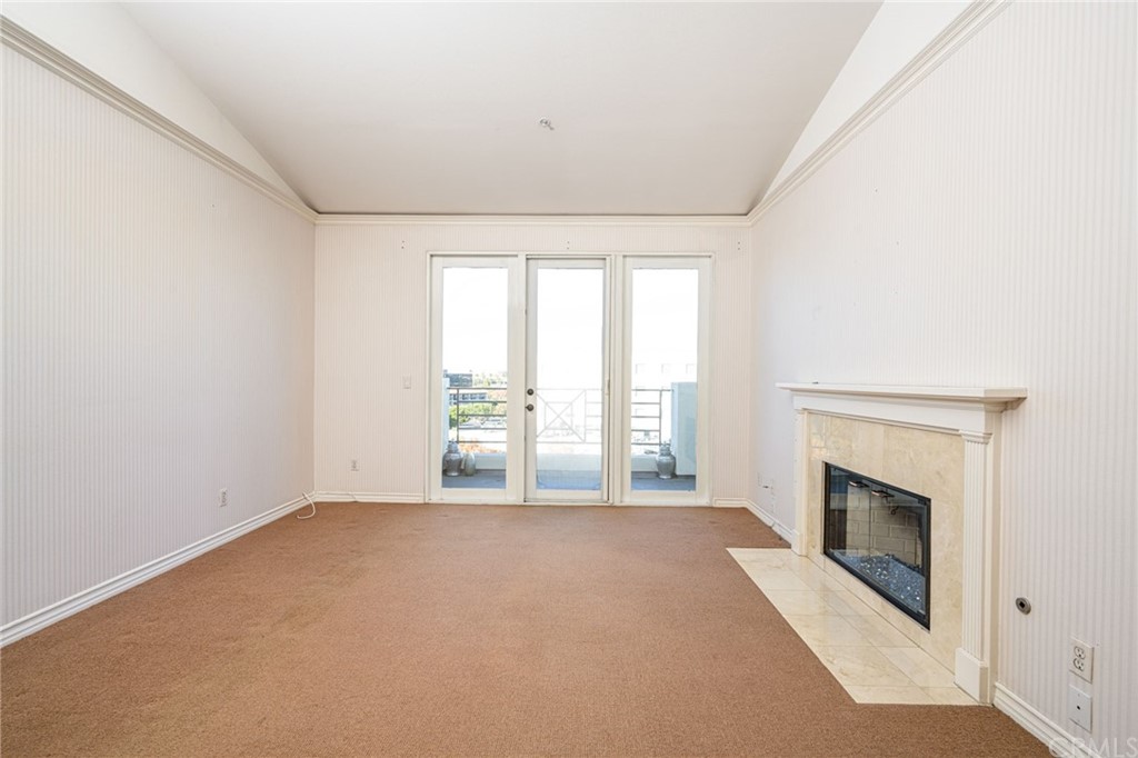 2243 Martin, Unit 409 Irvine, CA 92612 - Photo 11 of 43 an empty room with windows and fireplace