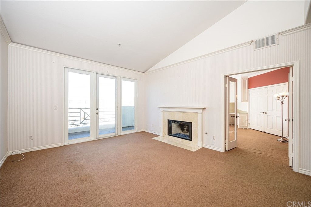 2243 Martin, Unit 409 Irvine, CA 92612 - Photo 12 of 43 a view of an empty room with a fireplace and a window