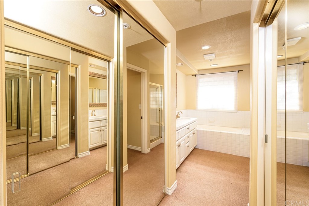 2243 Martin, Unit 409 Irvine, CA 92612 - Photo 22 of 43 a bathroom with a tub shower and sink