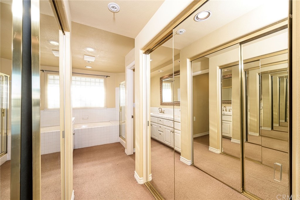 2243 Martin, Unit 409 Irvine, CA 92612 - Photo 23 of 43 a bathroom with a glass shower door and a glass door