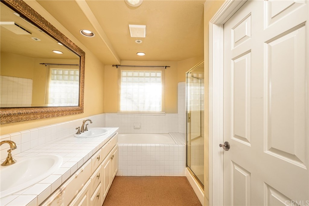 2243 Martin, Unit 409 Irvine, CA 92612 - Photo 24 of 43 a bathroom with a tub sink and mirror