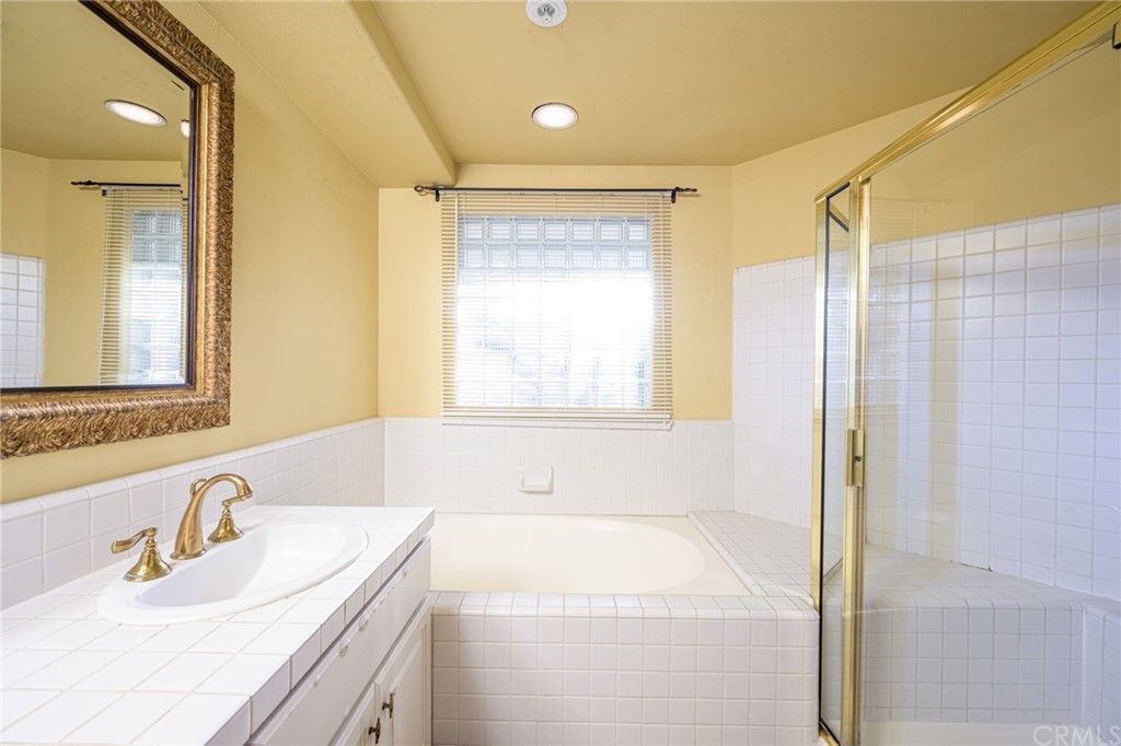 2243 Martin, Unit 409 Irvine, CA 92612 - Photo 25 of 43 a bathroom with a sink and a mirror
