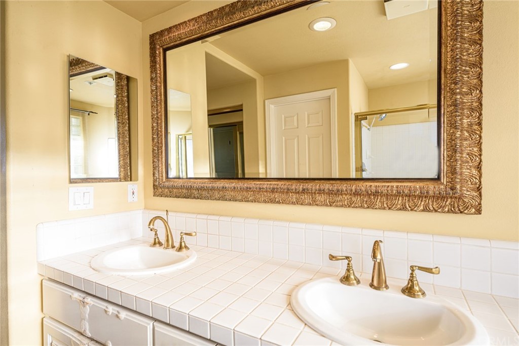 2243 Martin, Unit 409 Irvine, CA 92612 - Photo 26 of 43 a bathroom with a sink and a mirror