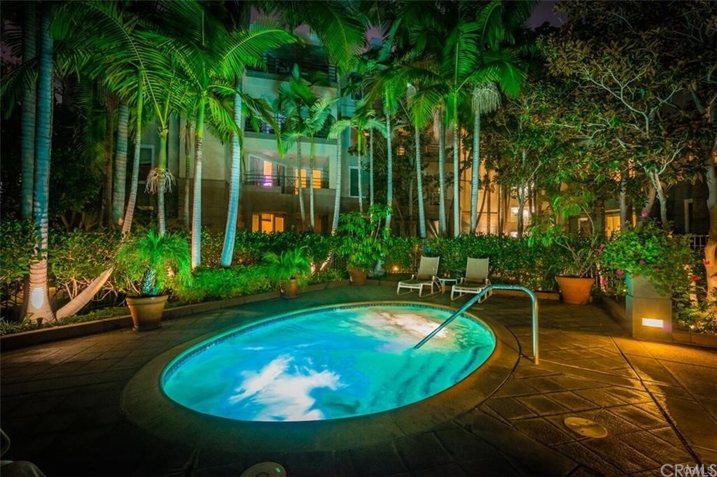 2243 Martin, Unit 409 Irvine, CA 92612 - Photo 39 of 43 a view of a swimming pool with a table and chairs