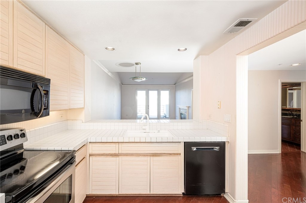 2243 Martin, Unit 409 Irvine, CA 92612 - Photo 6 of 43 a kitchen with stainless steel appliances granite countertop a sink and cabinets