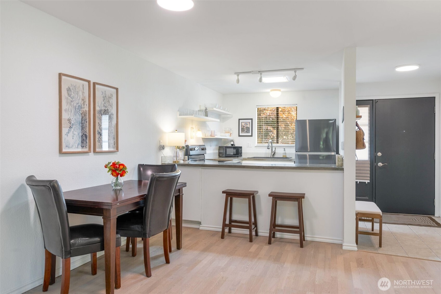 8017 196th Street Southwest, Unit 6B Edmonds, WA 98026 - Photo 8 of 23 a kitchen with stainless steel appliances granite countertop a dining table chairs and granite counter tops