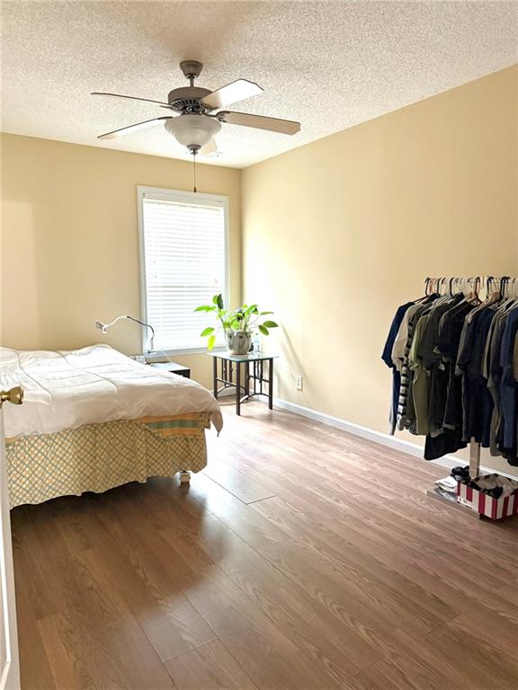 181 Masters Cove Macon, GA 31211 - Photo 9 of 16 a bedroom with a bed and a chandelier