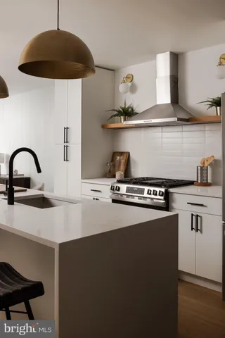 a kitchen with a sink a stove and cabinets