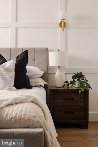 a bed sitting in a bedroom and wooden floor