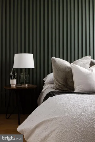 a bedroom with a bed and a chair