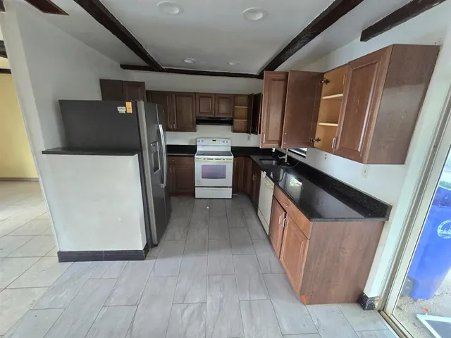 a kitchen with a refrigerator a sink and dishwasher