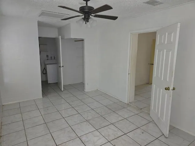 a view of an empty room and closet area