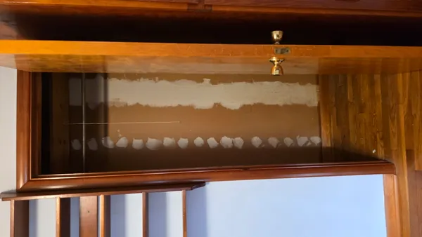 a view of a closet with wooden floor