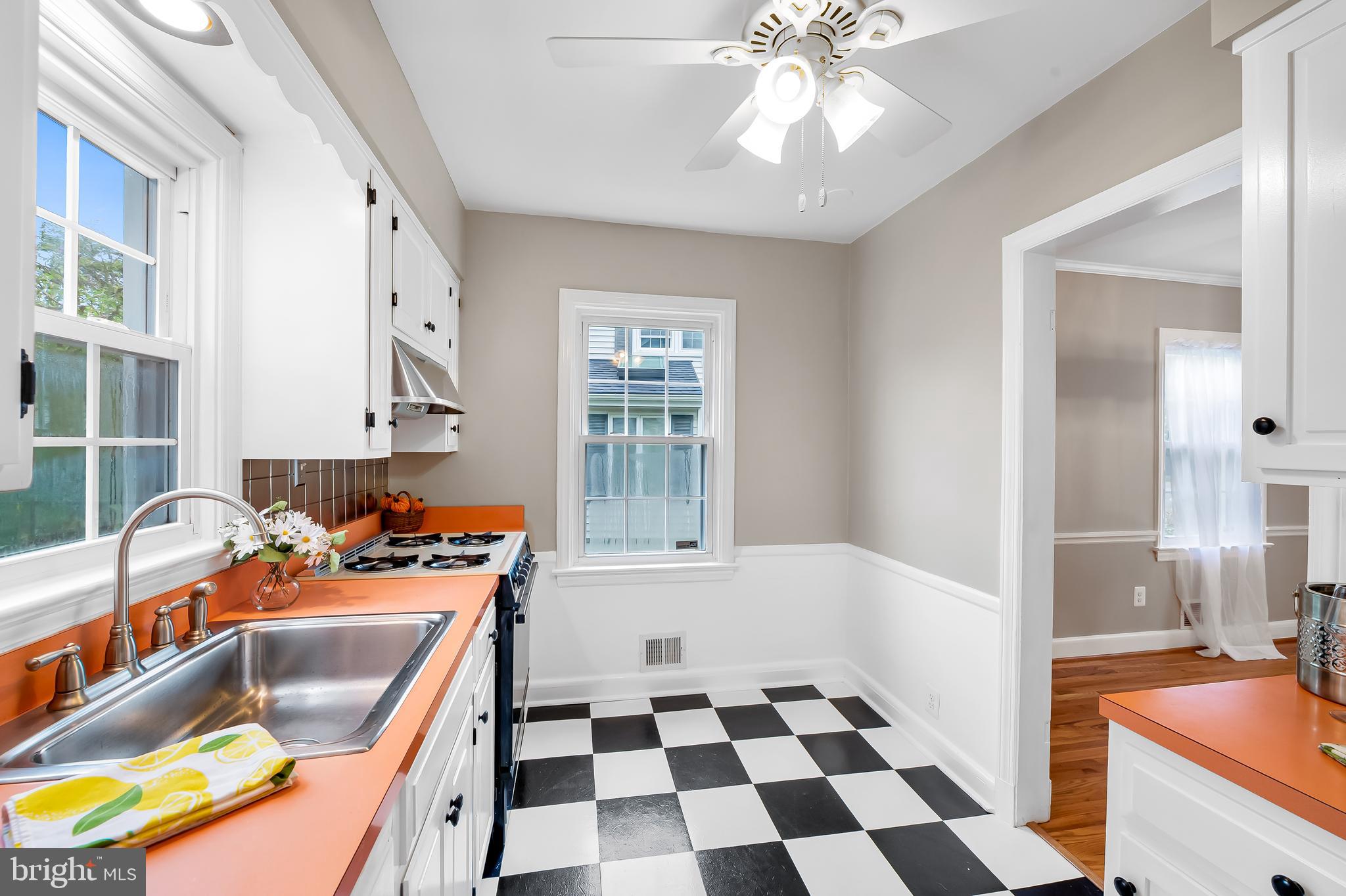 1238 Lake Falls Road Baltimore, MD 21210 - Photo 11 of 28 a kitchen with stainless steel appliances granite countertop a stove a sink and a microwave