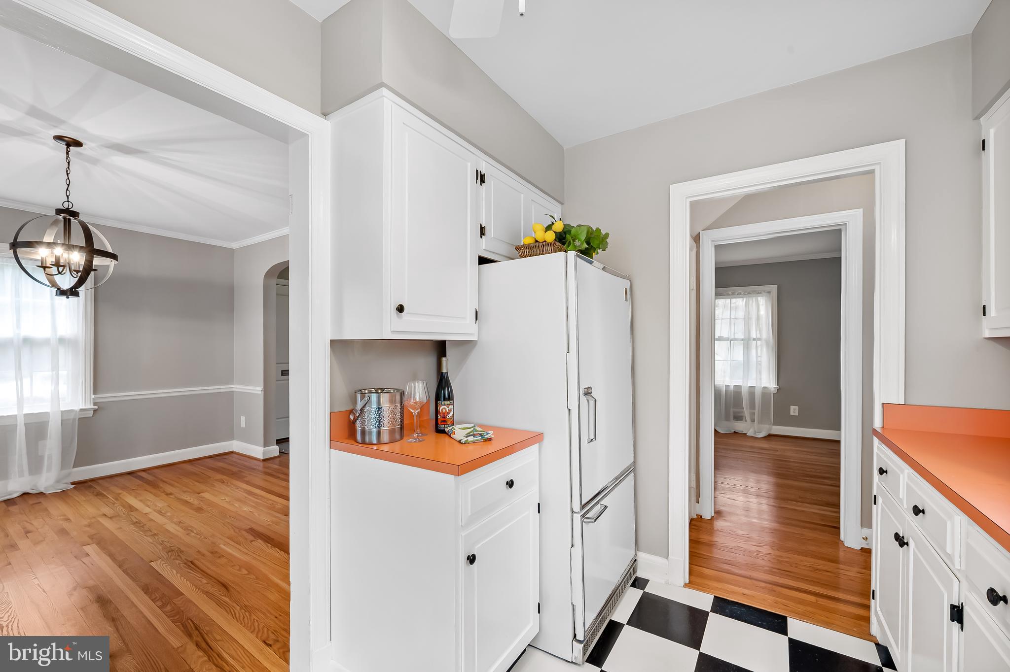 1238 Lake Falls Road Baltimore, MD 21210 - Photo 12 of 28 a open kitchen with white cabinets and wooden floor