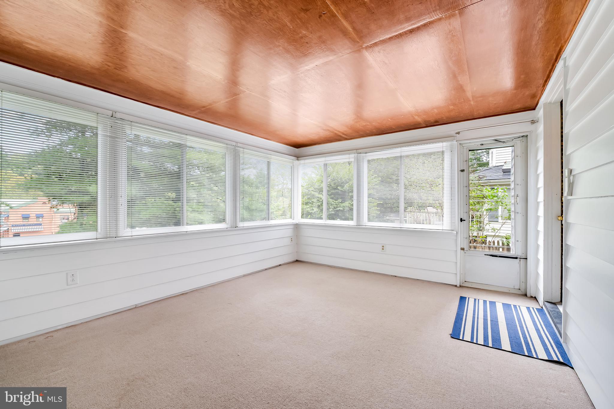 1238 Lake Falls Road Baltimore, MD 21210 - Photo 13 of 28 an empty room with wooden floor and windows