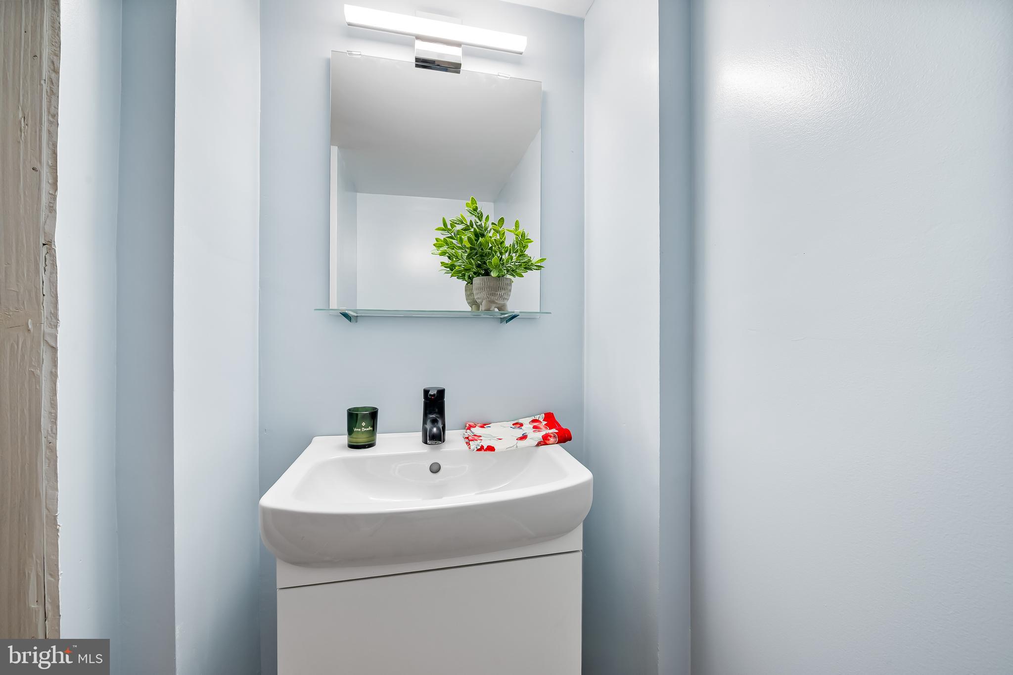 1238 Lake Falls Road Baltimore, MD 21210 - Photo 19 of 28 a bathroom with a sink and mirror