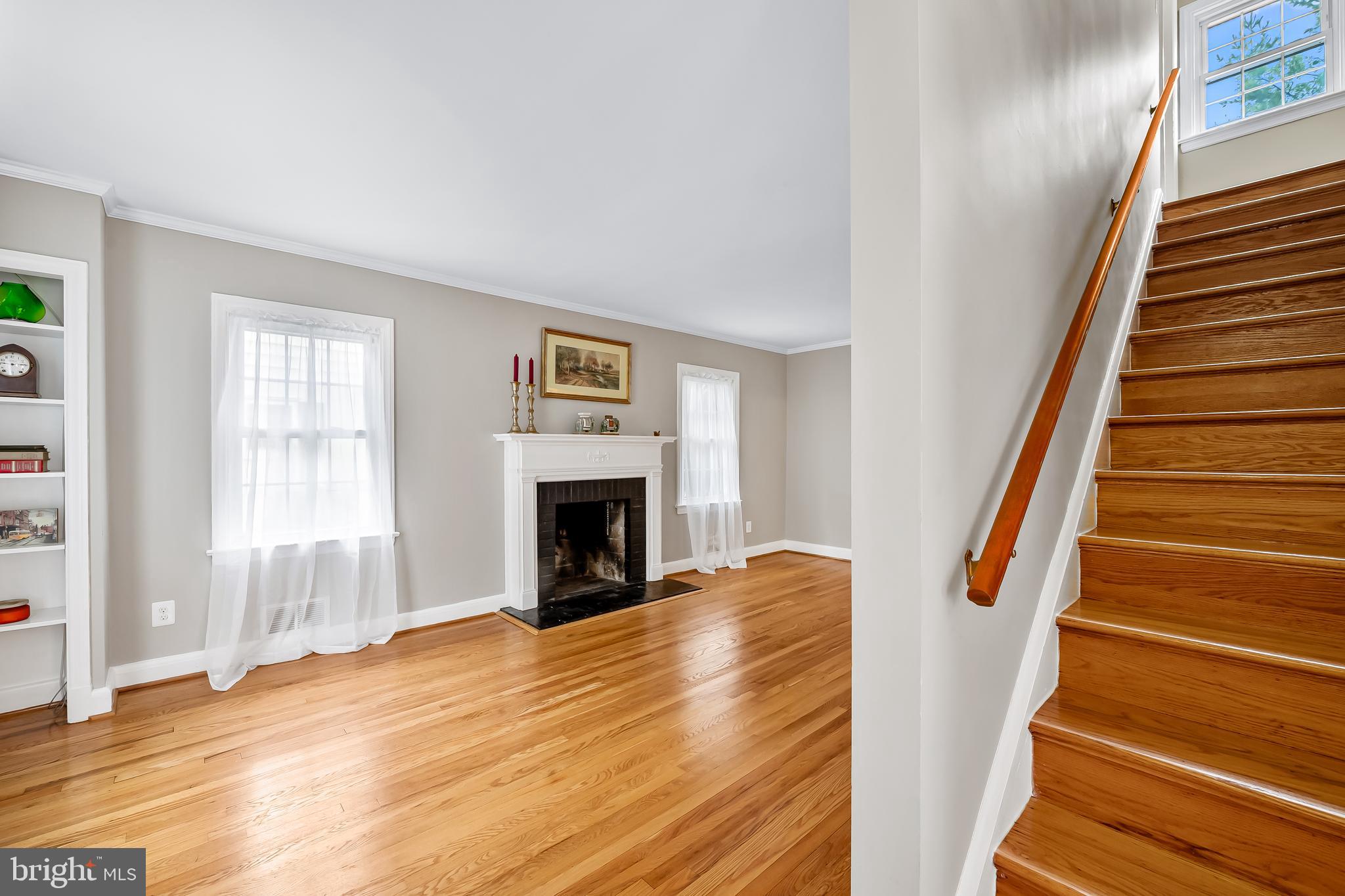 1238 Lake Falls Road Baltimore, MD 21210 - Photo 4 of 28 a view of a livingroom with wooden floor and a fireplace