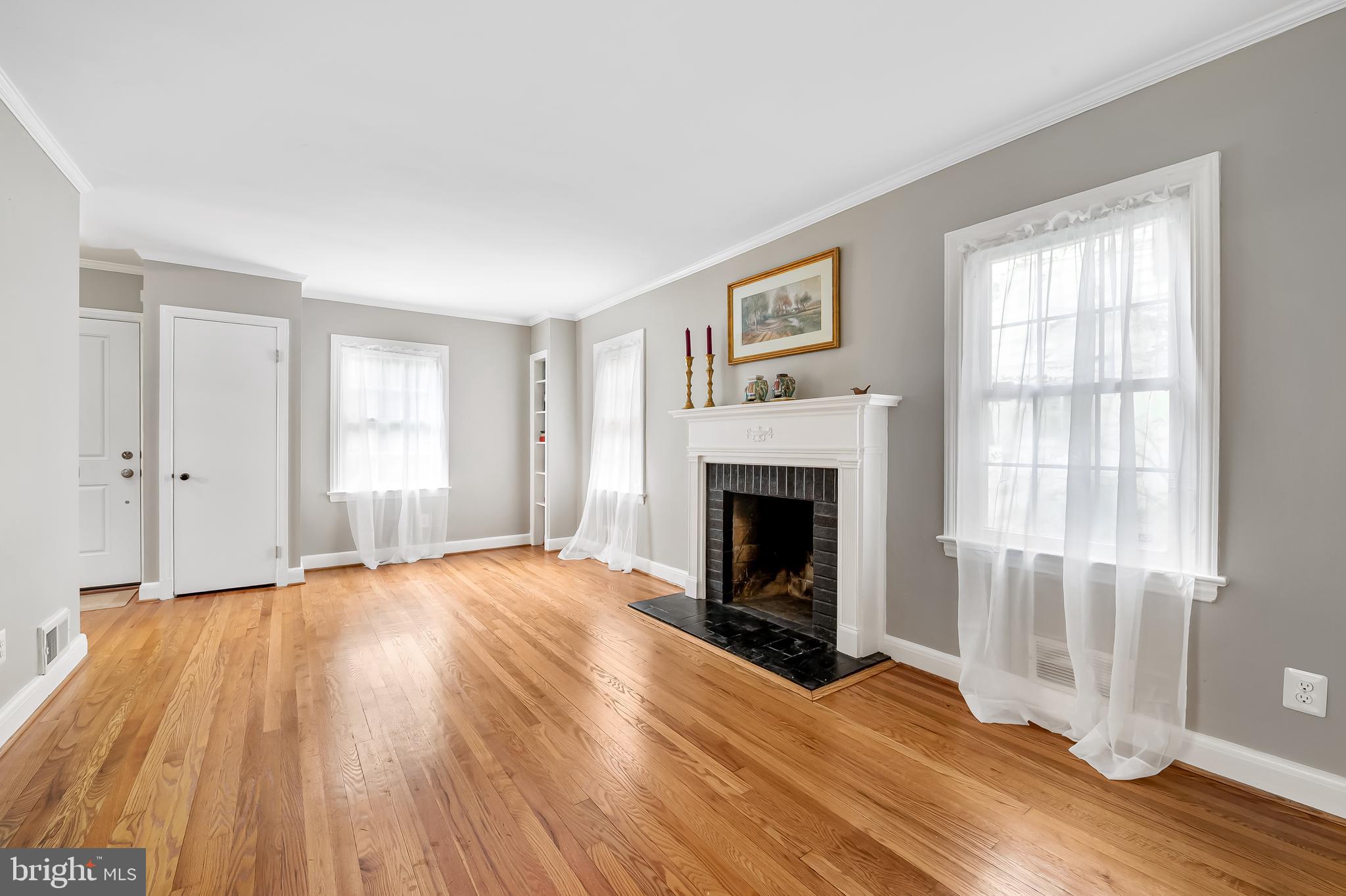 1238 Lake Falls Road Baltimore, MD 21210 - Photo 5 of 28 a view of empty room with wooden floor and fireplace