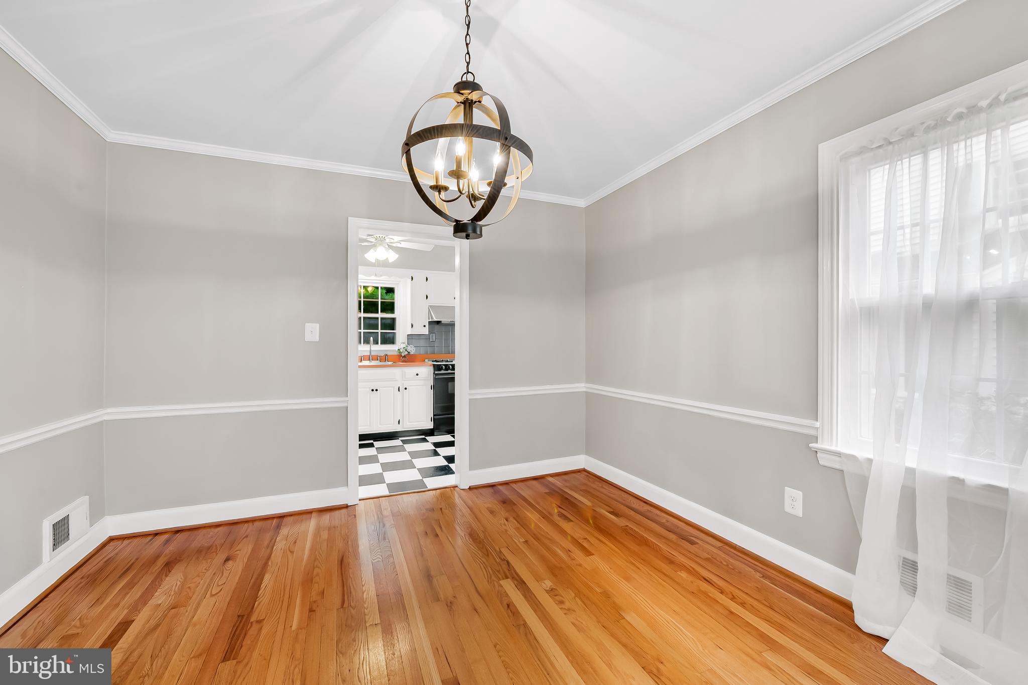 1238 Lake Falls Road Baltimore, MD 21210 - Photo 8 of 28 a view of empty room with wooden floor and window