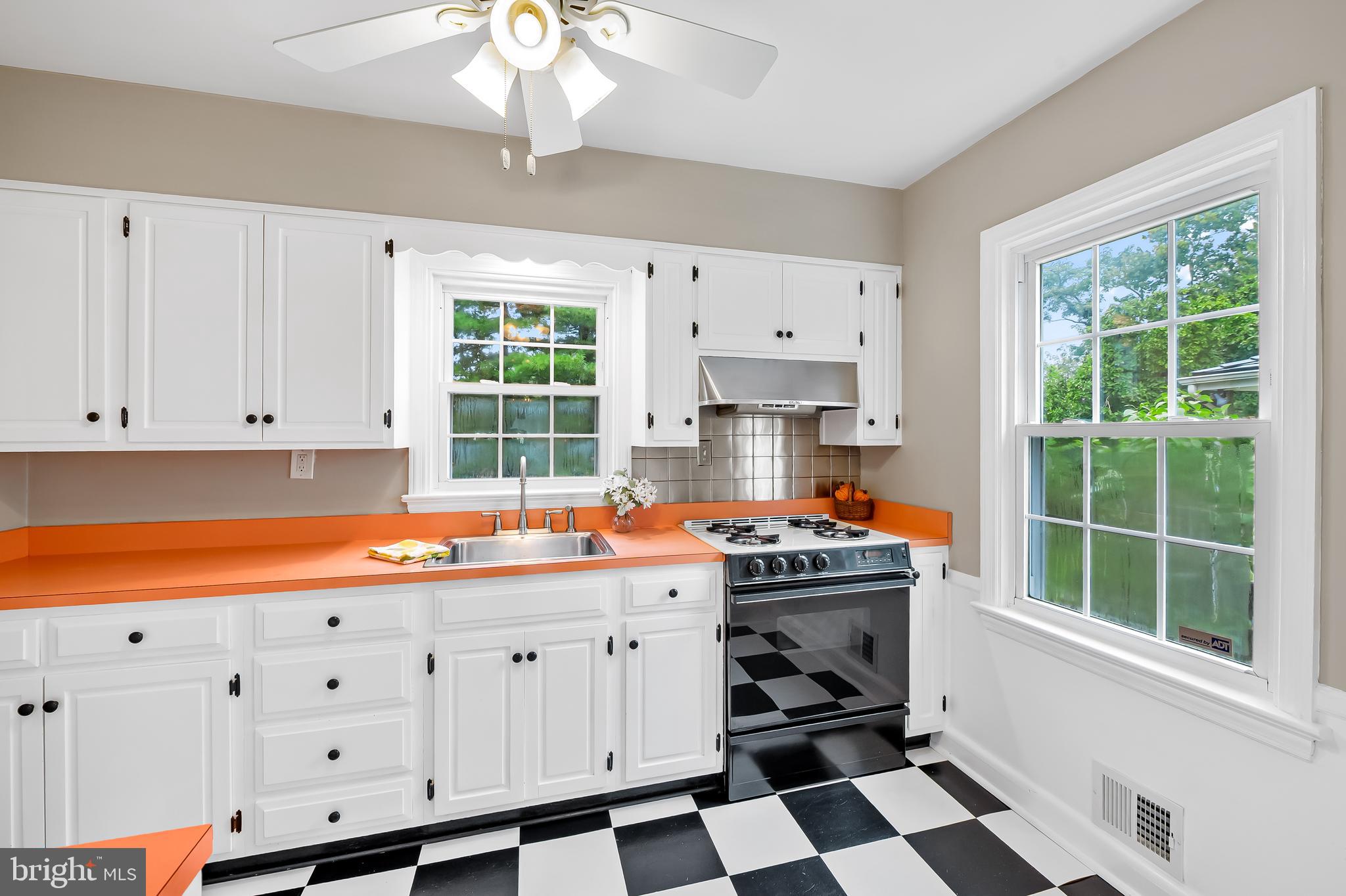 1238 Lake Falls Road Baltimore, MD 21210 - Photo 9 of 28 a kitchen with stainless steel appliances a stove a sink and a window
