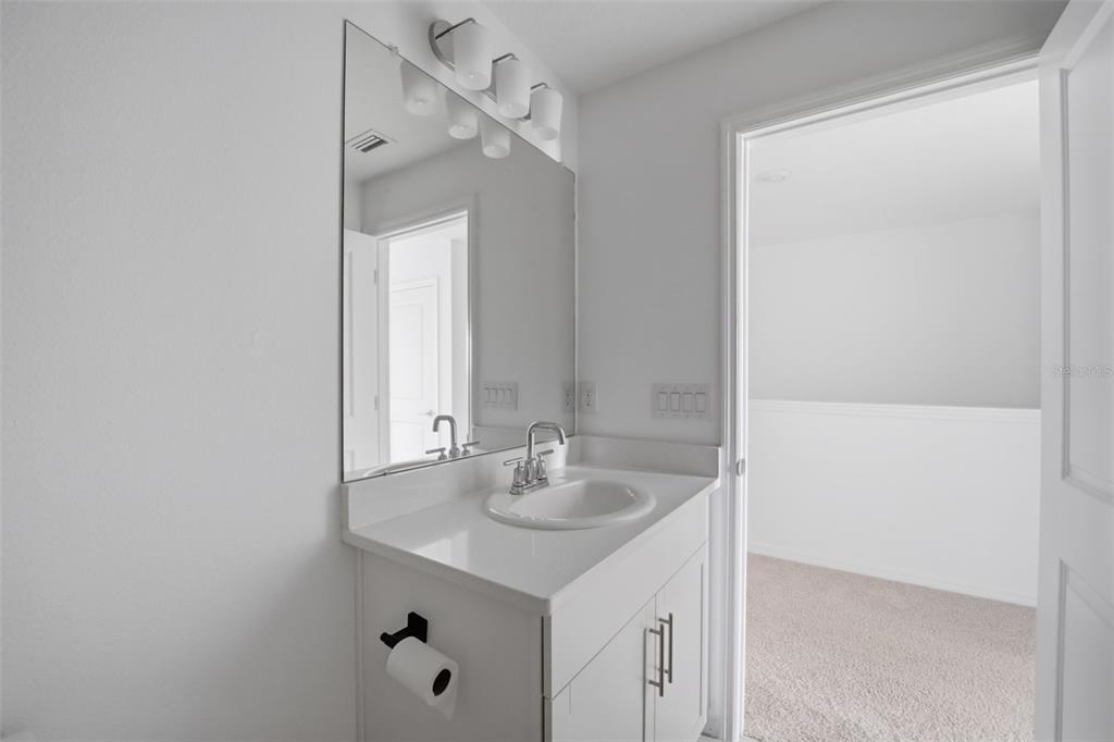 2407 Paravane Way Wesley Chapel, FL 33543 - Photo 12 of 32 a bathroom with a sink and a mirror