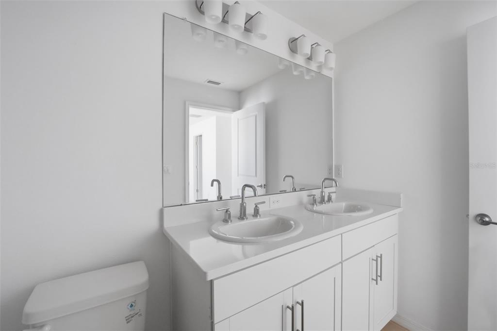 2407 Paravane Way Wesley Chapel, FL 33543 - Photo 13 of 32 a bathroom with a sink toilet and a mirror
