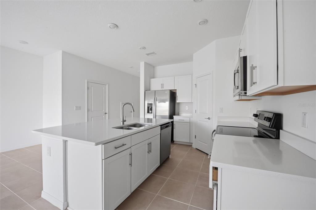 2407 Paravane Way Wesley Chapel, FL 33543 - Photo 5 of 32 a kitchen that has a sink and a stove in it