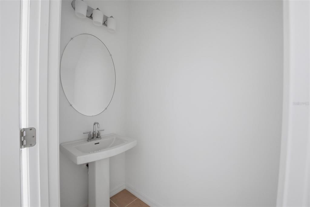 2407 Paravane Way Wesley Chapel, FL 33543 - Photo 10 of 32 a bathroom with a sink and mirror